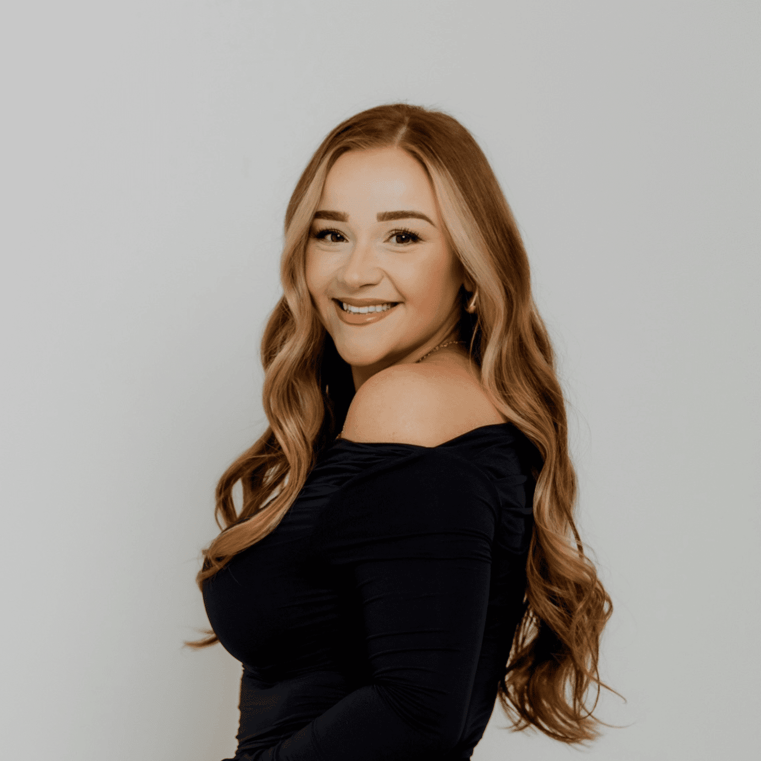 Portrait of Carley Smith, a professional stylist at The Hair Bar, showcasing their expertise and style.